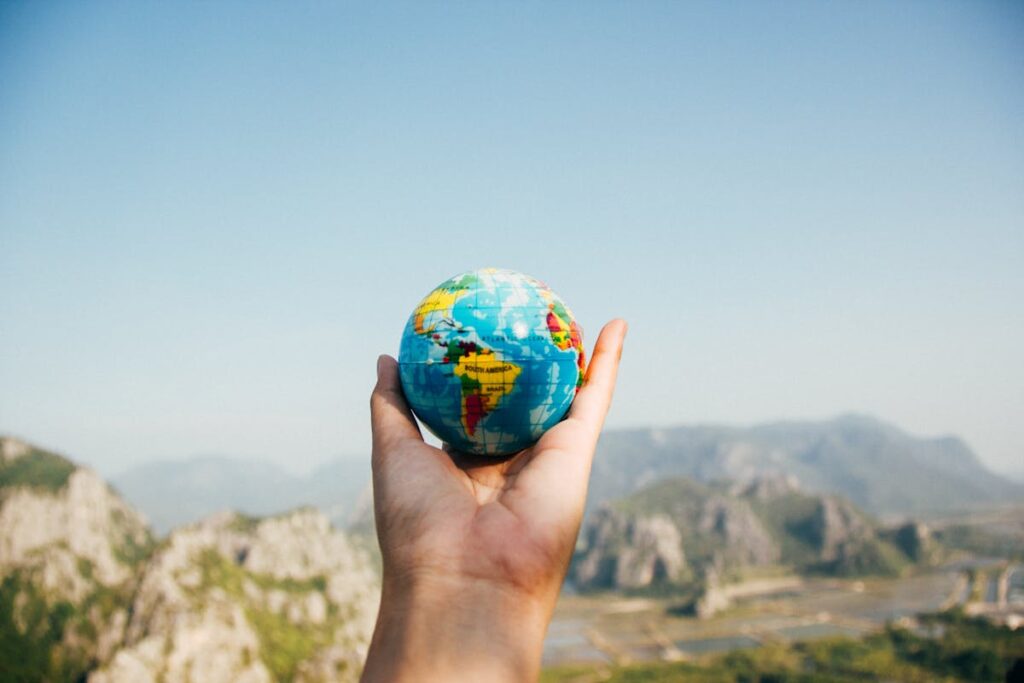Excited first-time traveler with backpack exploring a foreign city, surrounded by cultural landmarks and local people